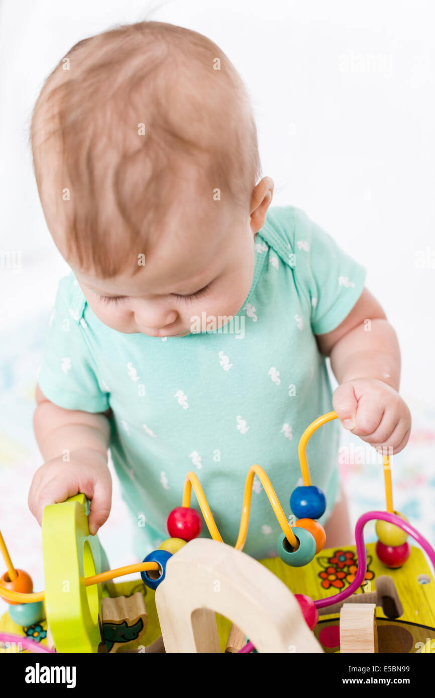 Cute baby girl playing with her toys on a blanket Stock Photo - Alamy