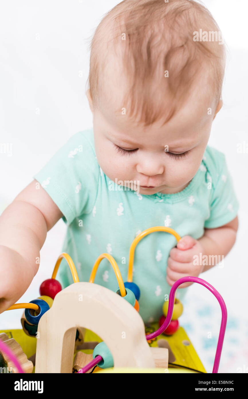Cute baby girl playing with her toys on a blanket Stock Photo - Alamy