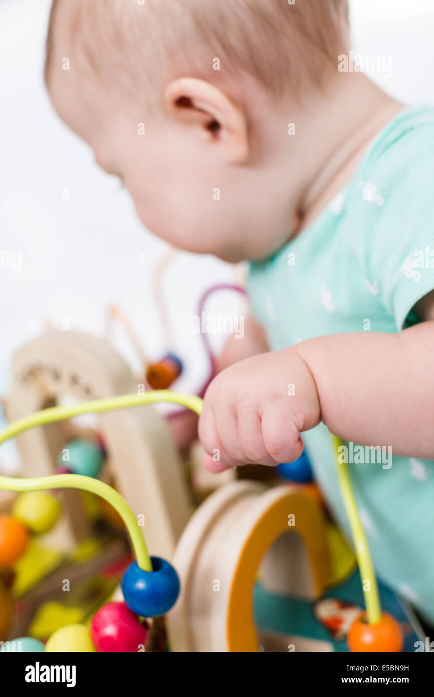 Cute baby girl playing with her toys on a blanket Stock Photo - Alamy
