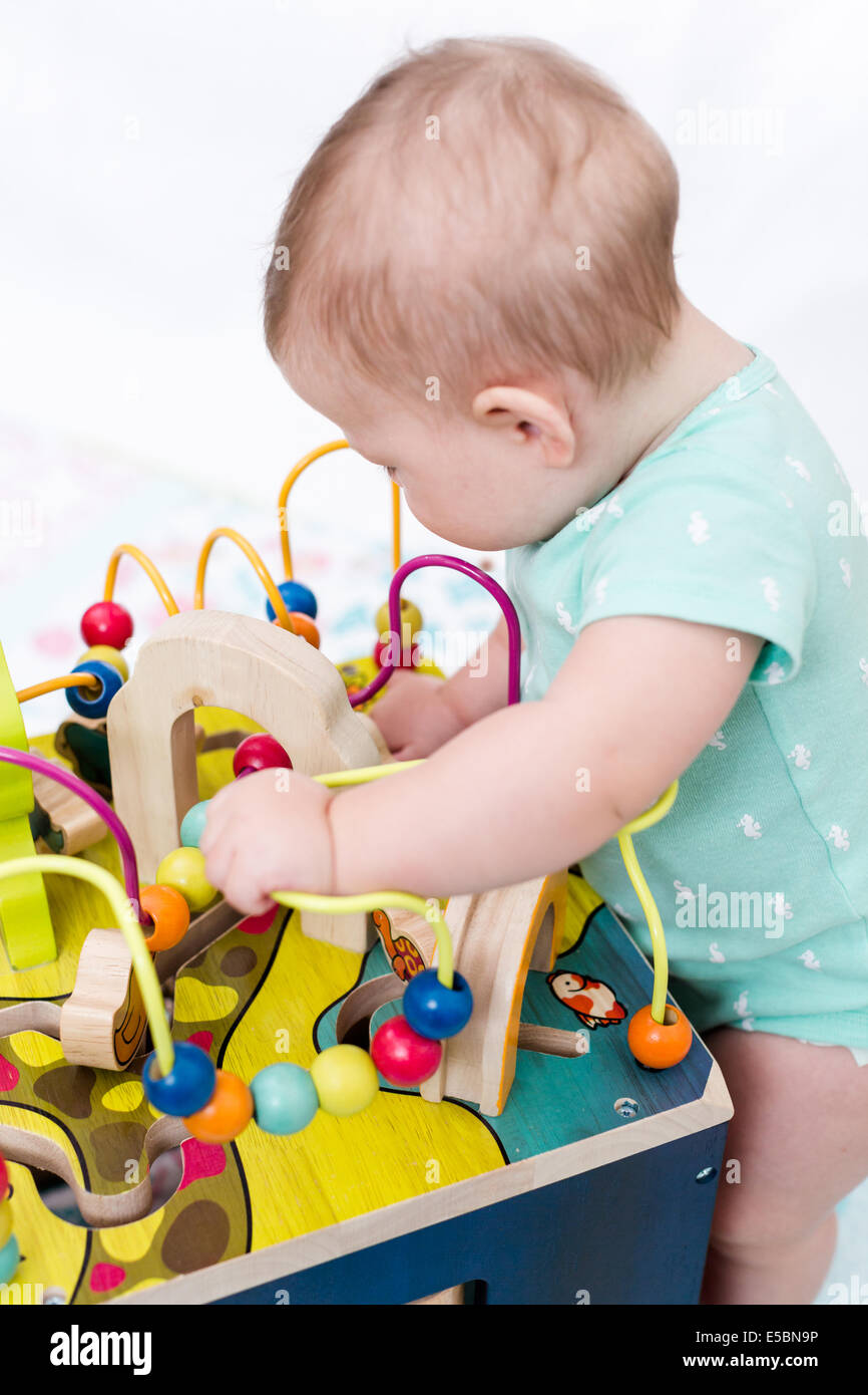 Cute baby girl playing with her toys on a blanket Stock Photo - Alamy