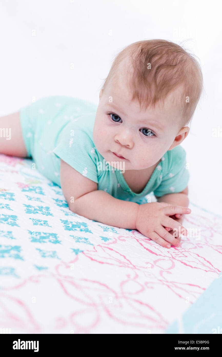 Cute baby girl playing with her toys on a blanket Stock Photo - Alamy