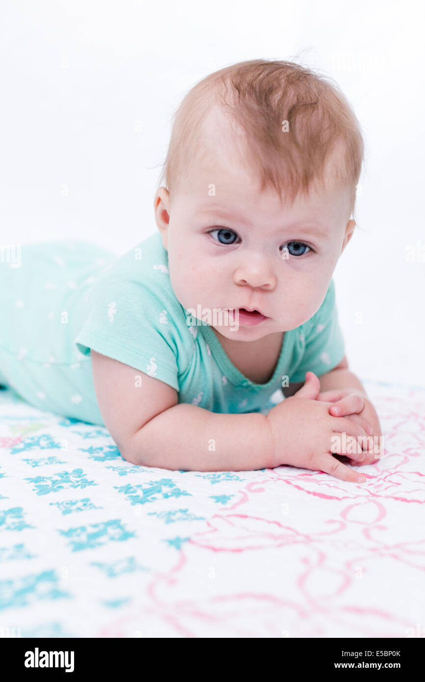 Cute baby girl playing with her toys on a blanket Stock Photo - Alamy