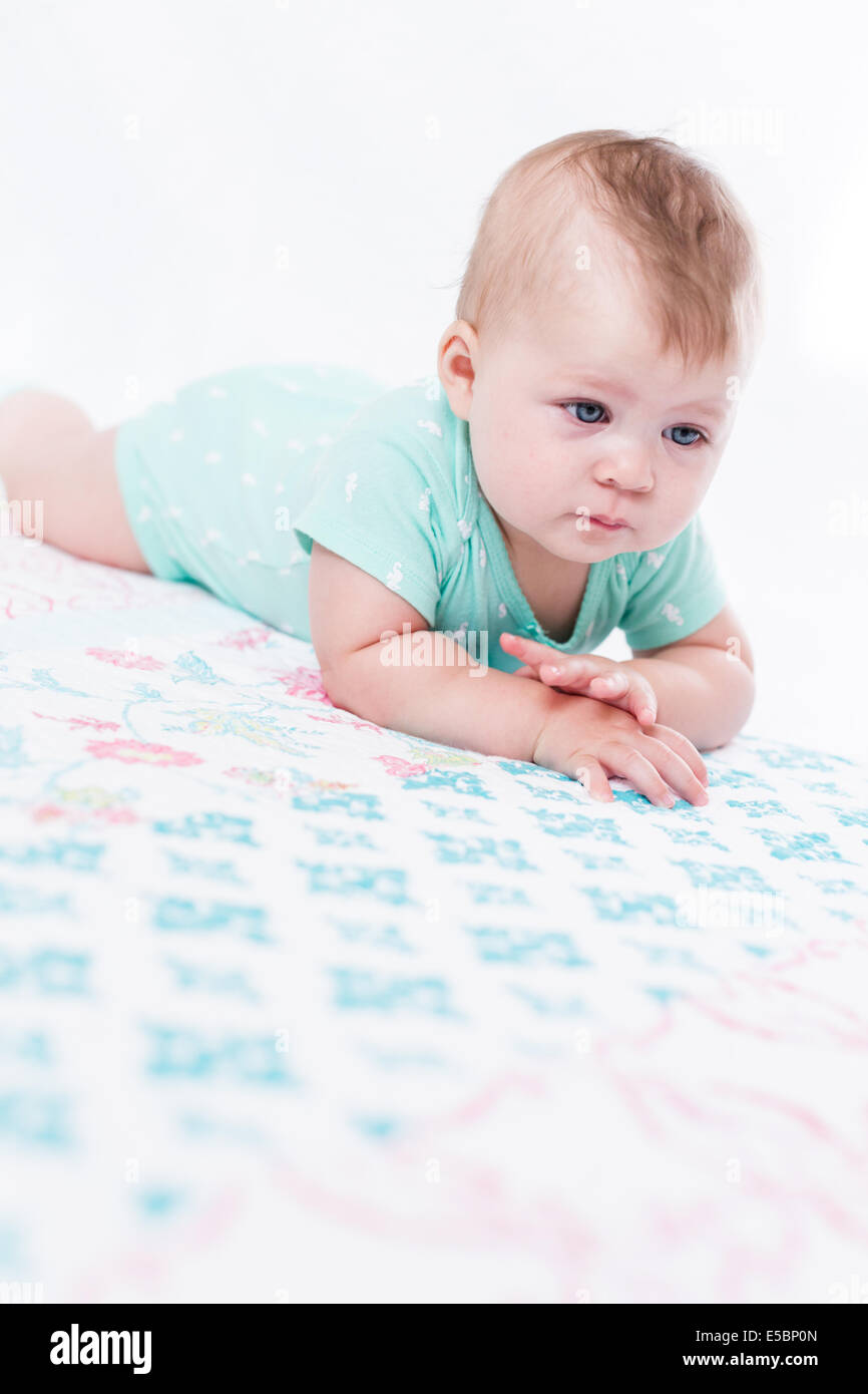 Cute baby girl playing with her toys on a blanket Stock Photo - Alamy