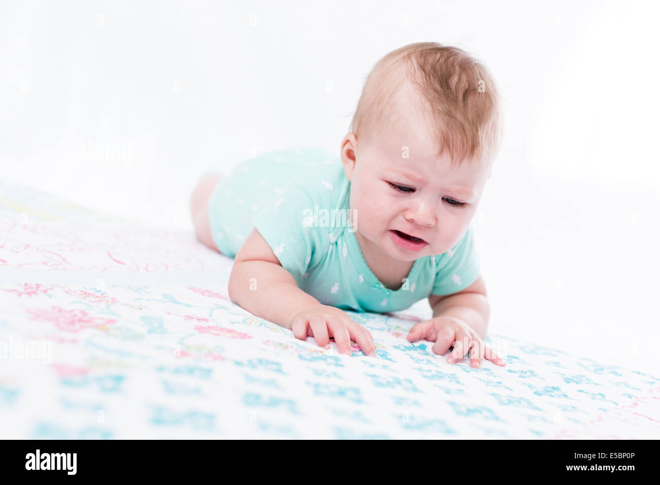 Cute baby girl playing with her toys on a blanket Stock Photo - Alamy
