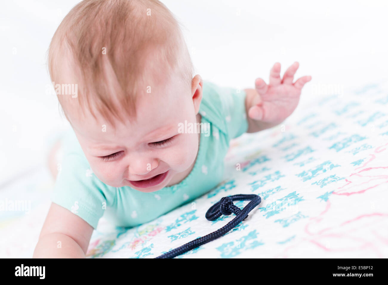 Cute baby girl playing with her toys on a blanket Stock Photo - Alamy