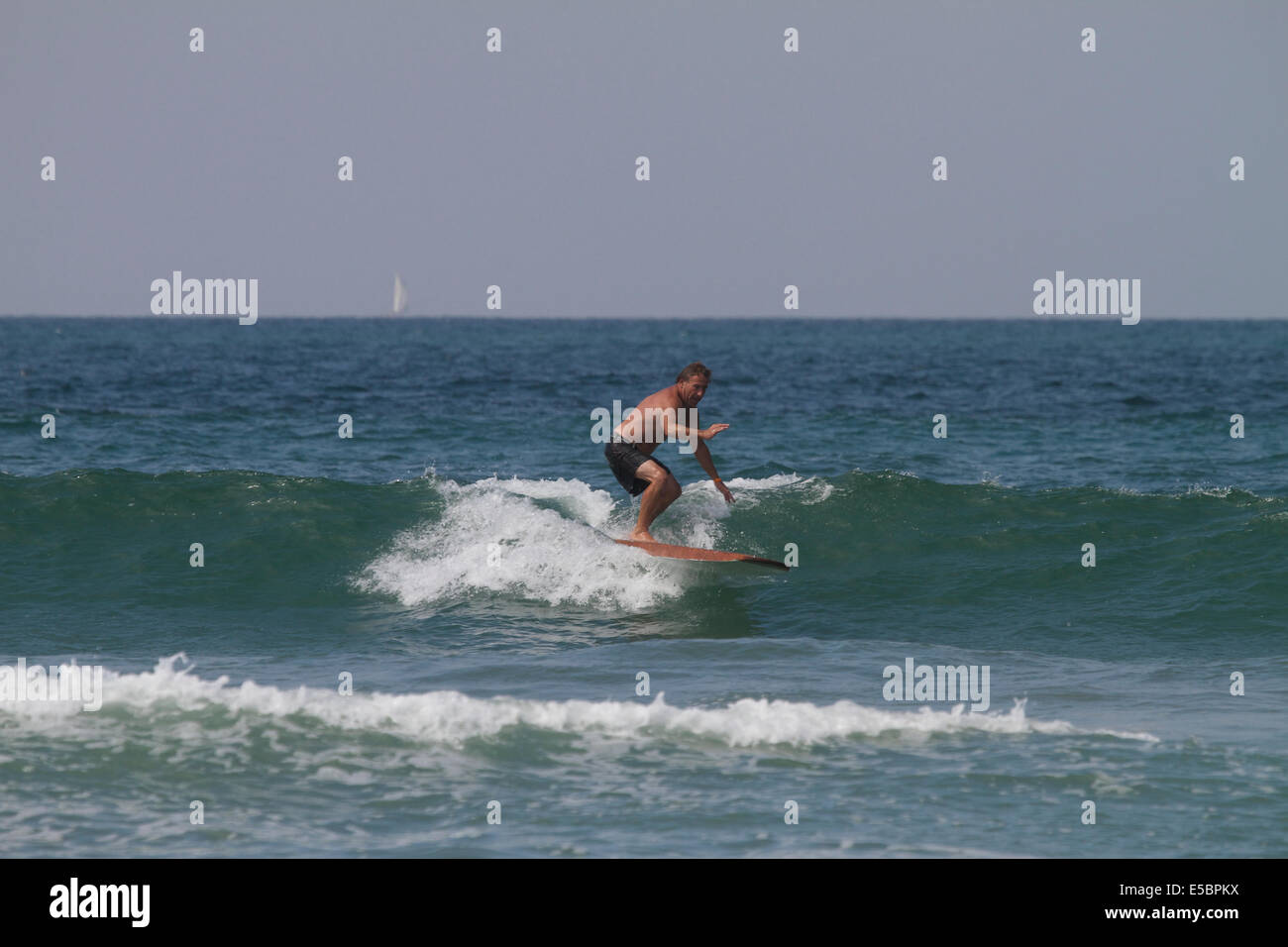 Riding a surfboard hi-res stock photography and images - Alamy