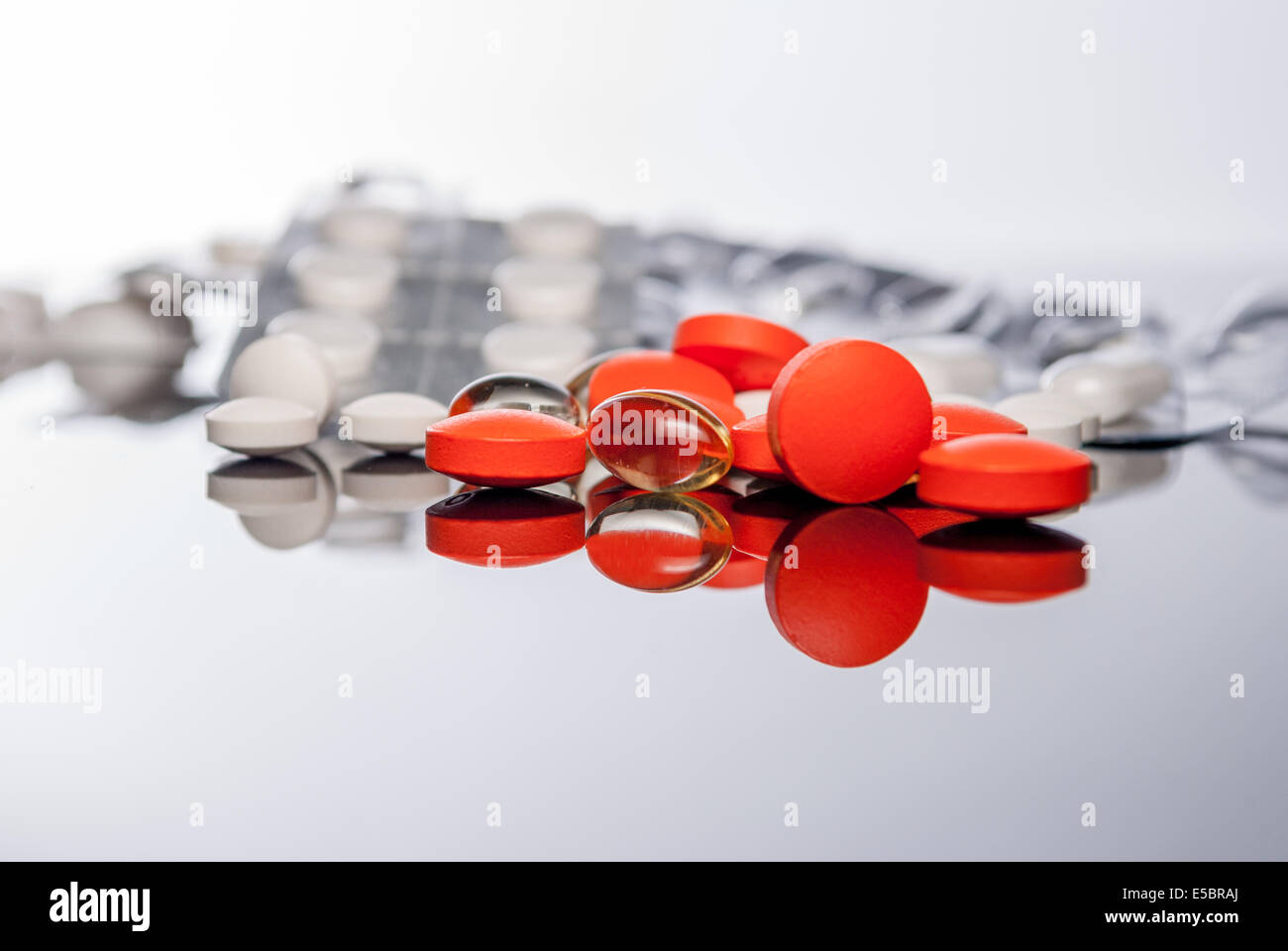 Colorful tablets or pills  on reflect background Stock Photo