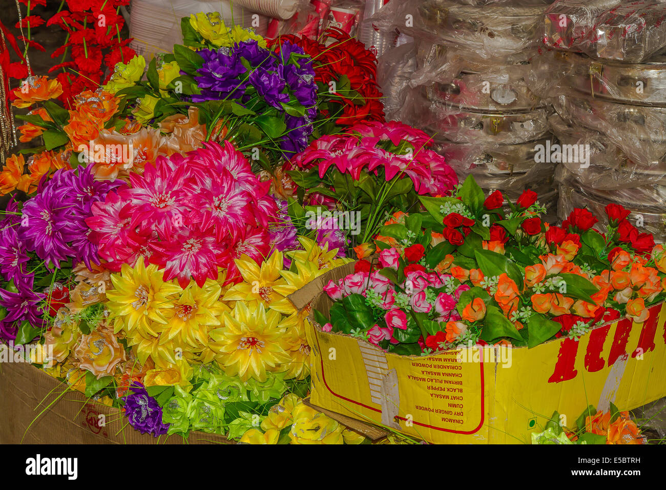 Collection of artificial flowers in boxes outside a florist Stock Photo