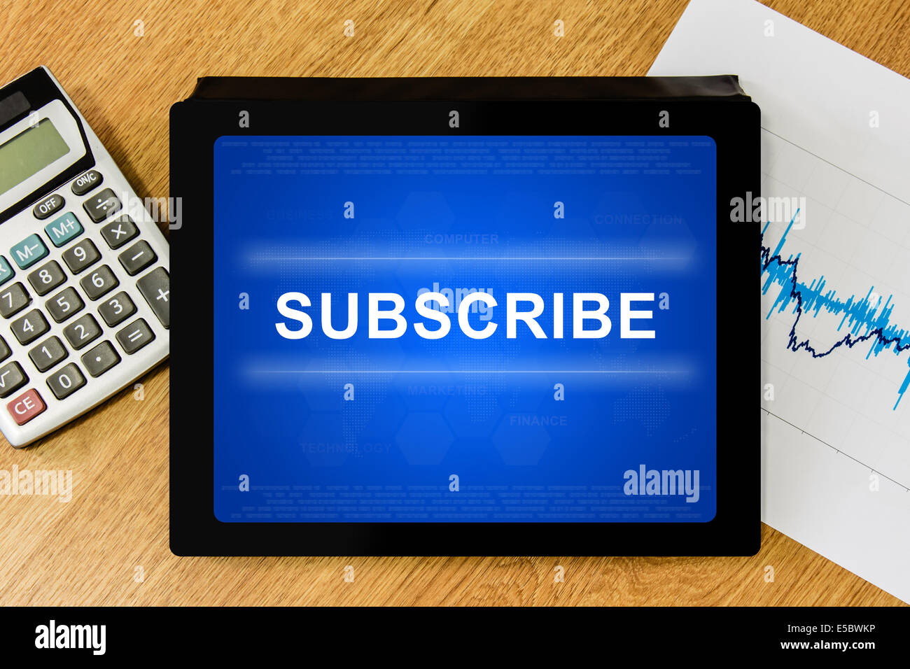subscribe word on digital tablet with calculator and financial graph Stock Photo