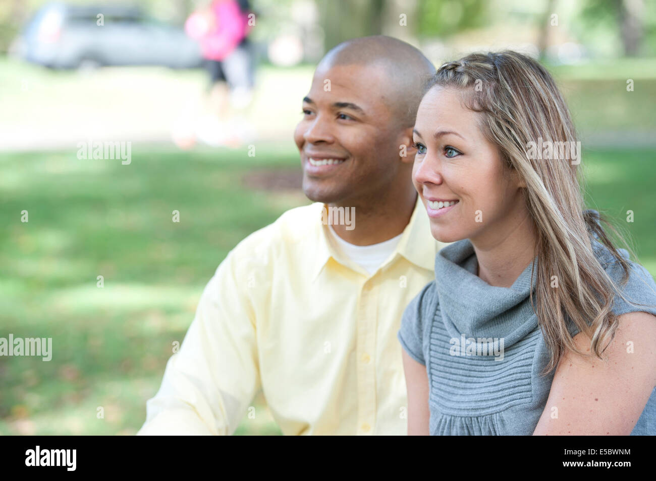 Happy young interracial couple posing together on a sunny day. Stock Photo