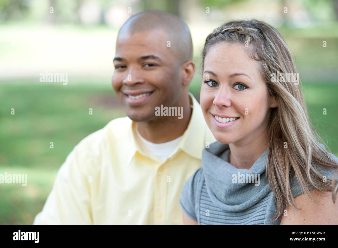 Happy young interracial couple posing together on a sunny day. Stock Photo
