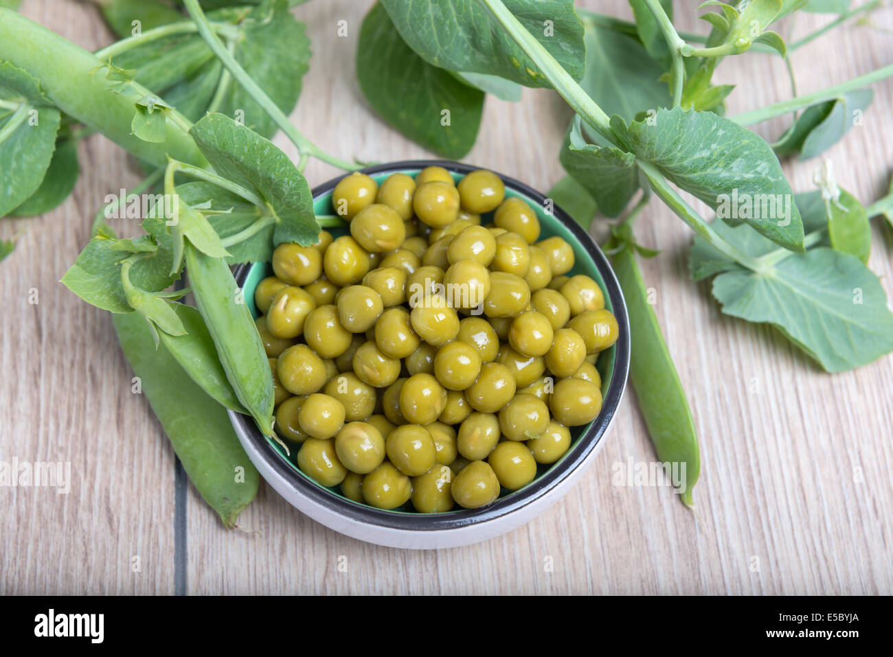 Boiled green peas in a cup, pods and branches Stock Photo Alamy
