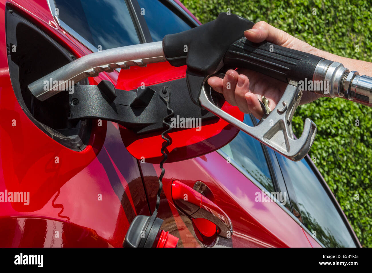 Pumping Gas - Filling a cars fuel tank with diesel. Stock Photo