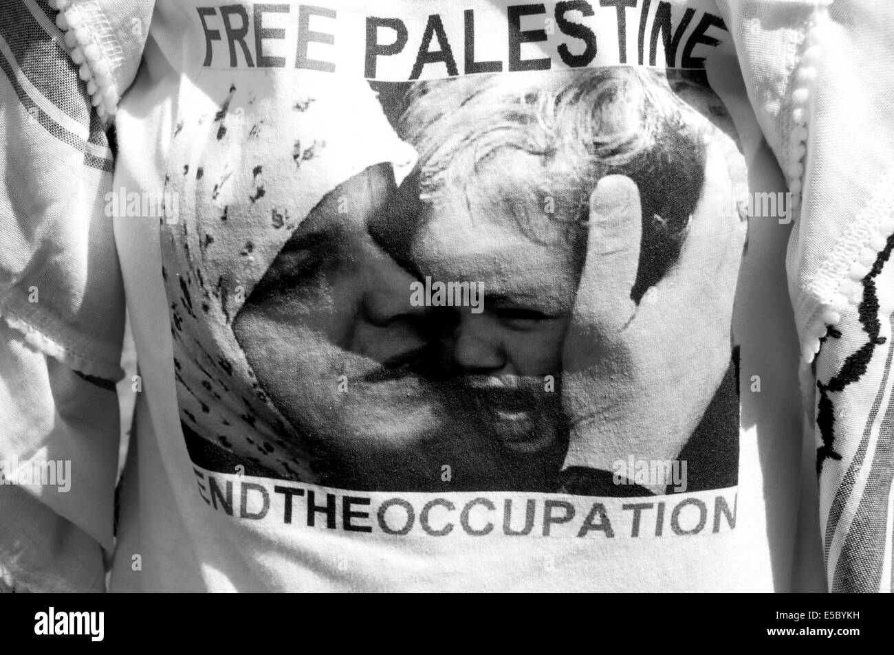 Demonstration against Israeli bombing of Gaza, 26.07.2014. A protester wears a t shirt with an image from the war Stock Photo