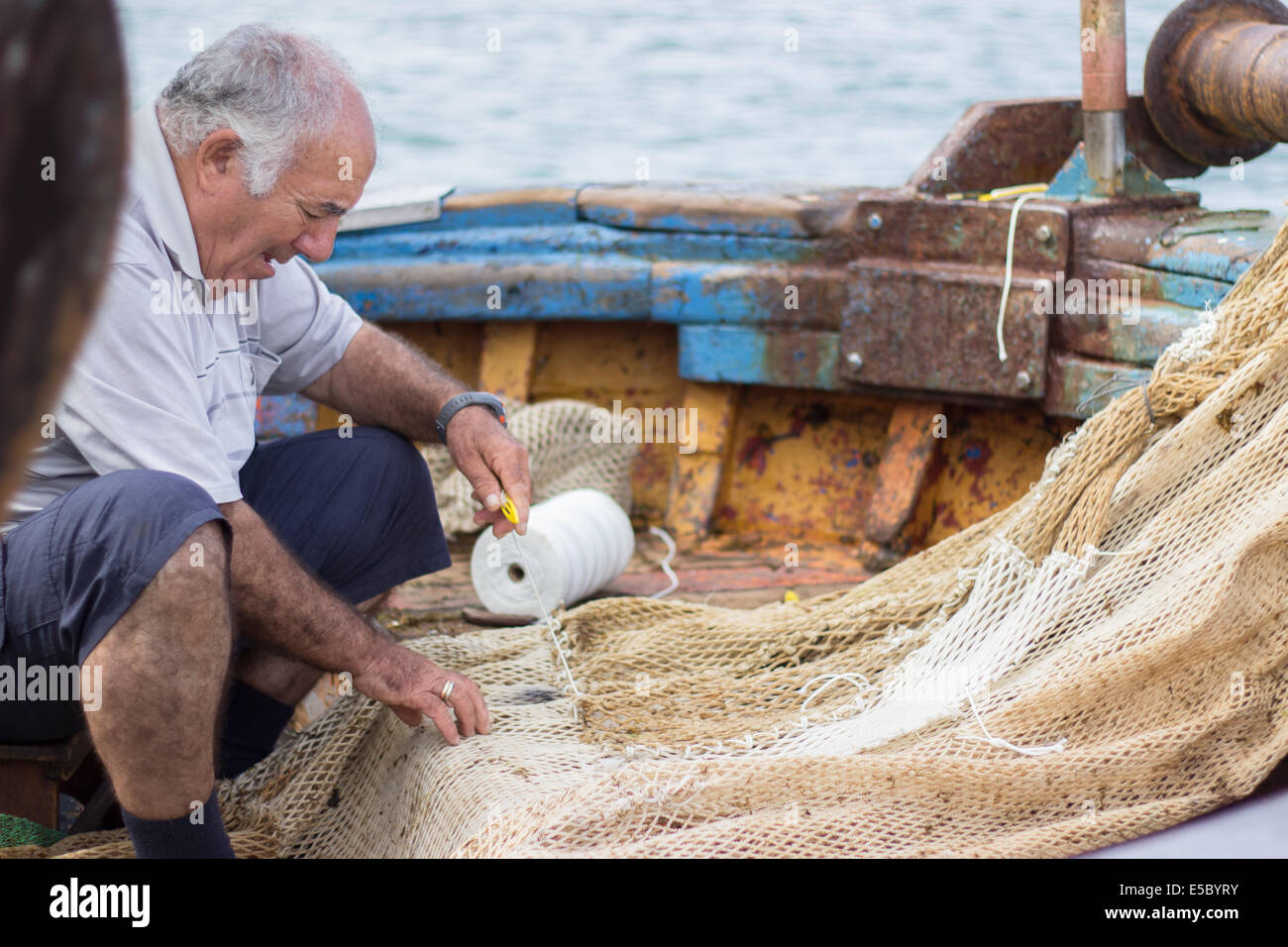 man weave weaving fishing net boat industrial working Stock Photo Alamy