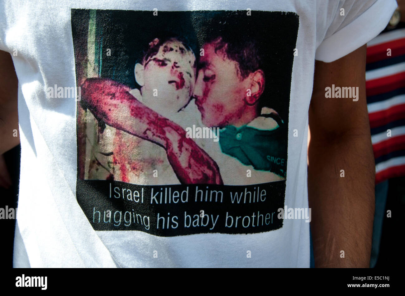 Demonstration against Israeli bombing of Gaza, 26.07.2014. A protester wears a t shirt with an image from the war Stock Photo