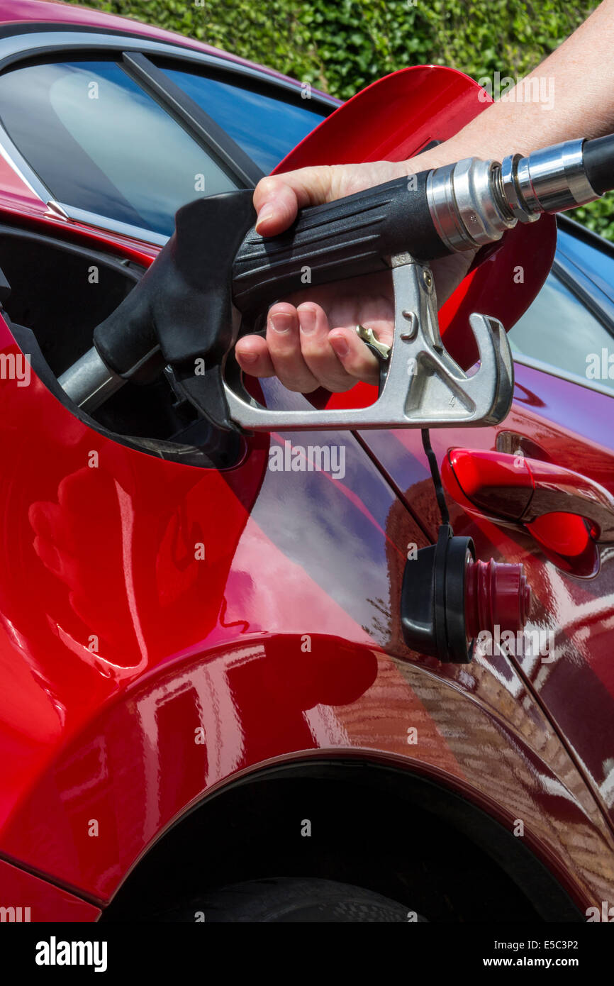 Pumping Gas - Filling a cars fuel tank with diesel or petroleum. Stock Photo