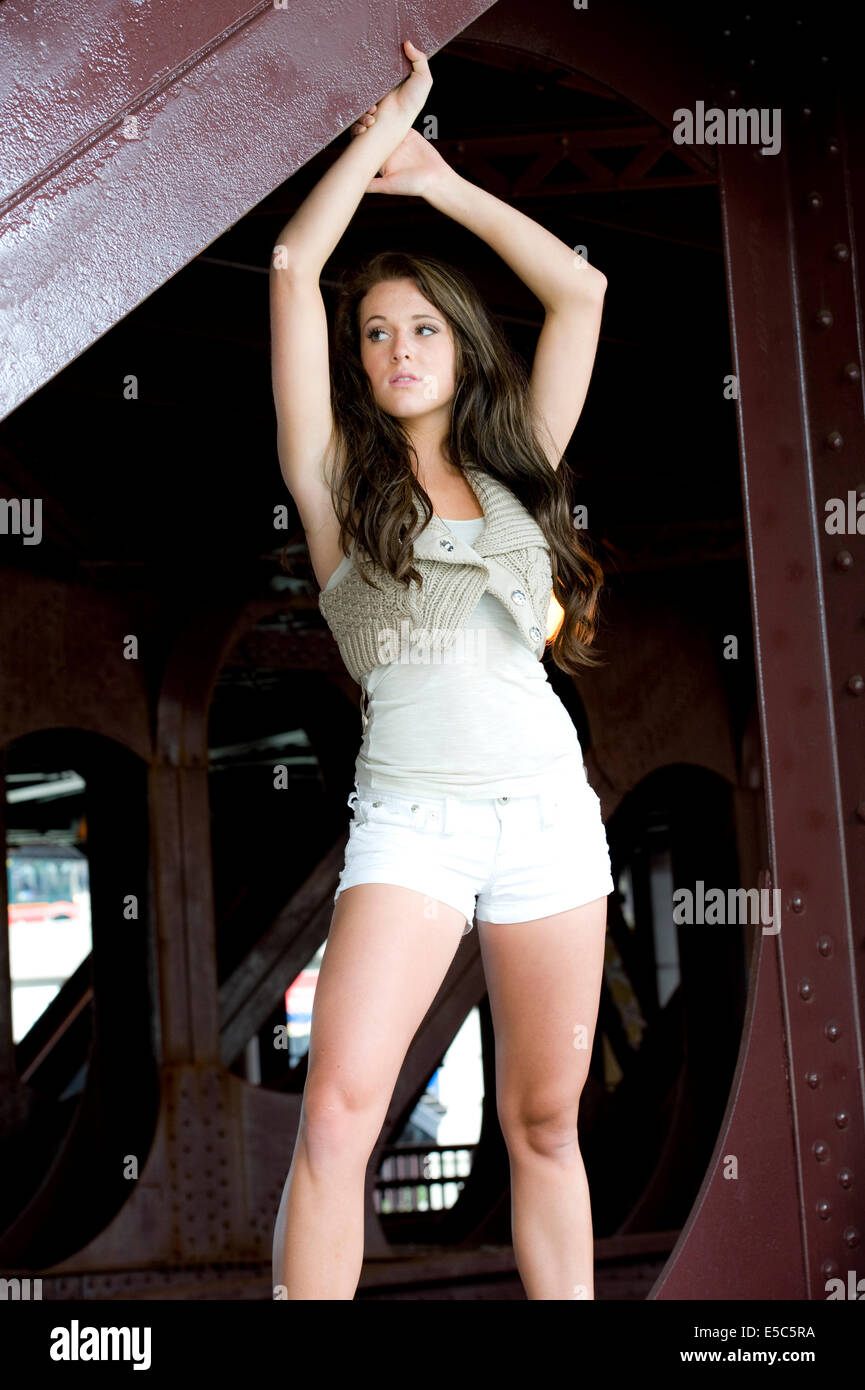 Gorgeous teen model wearing a white top and matching shorts on a sunny day Stock Photo photo