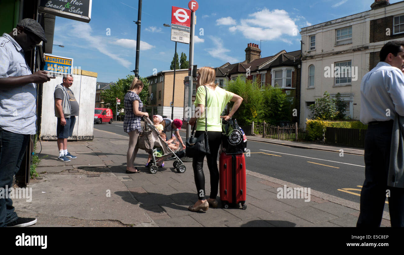People waiting for a bus at a Philip Lane bus stop in summer Tottenham, London N15 England UK  KATHY DEWITT Stock Photo