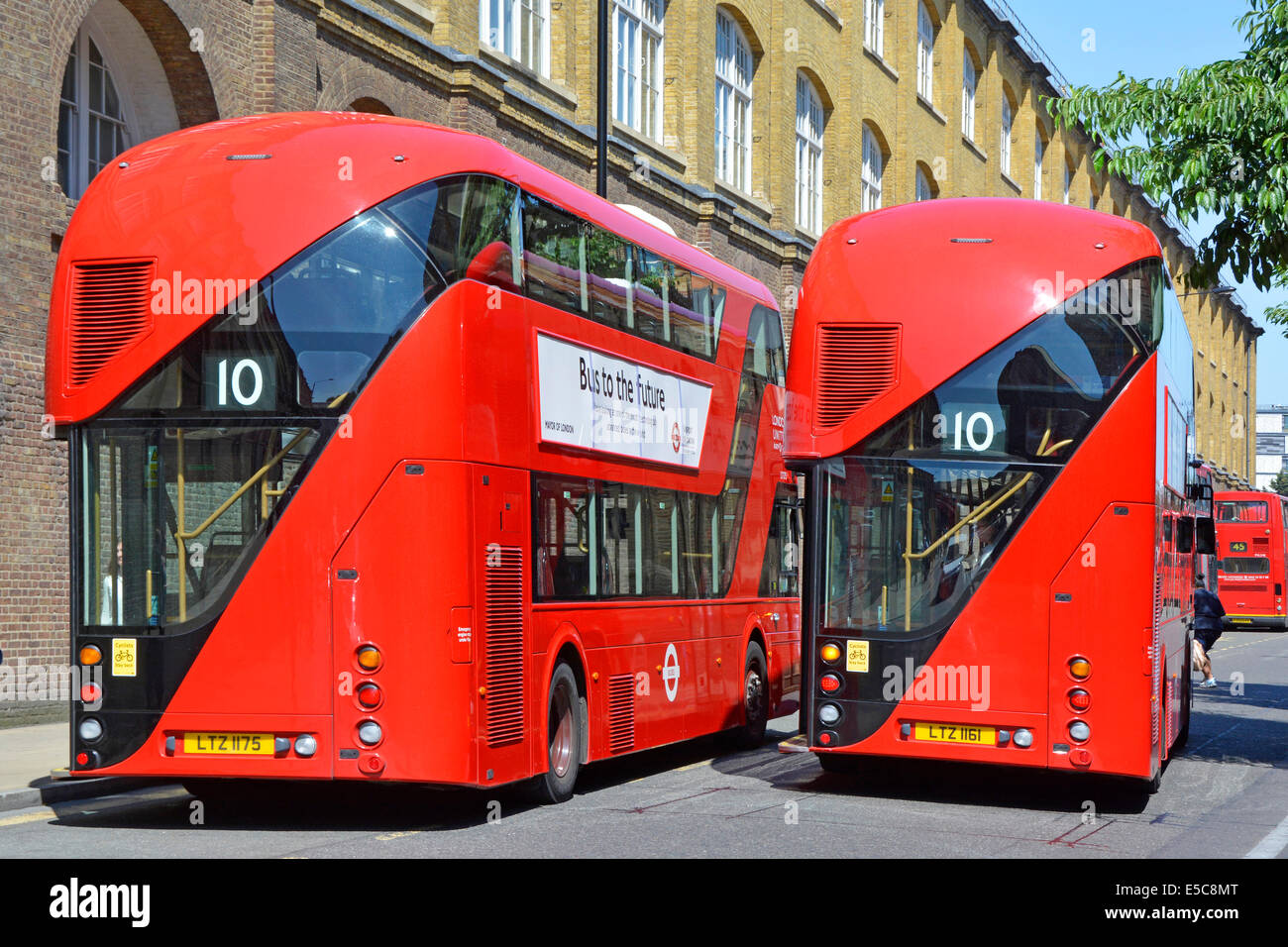 Pair of new red London Boris routemaster buses on bus stands during