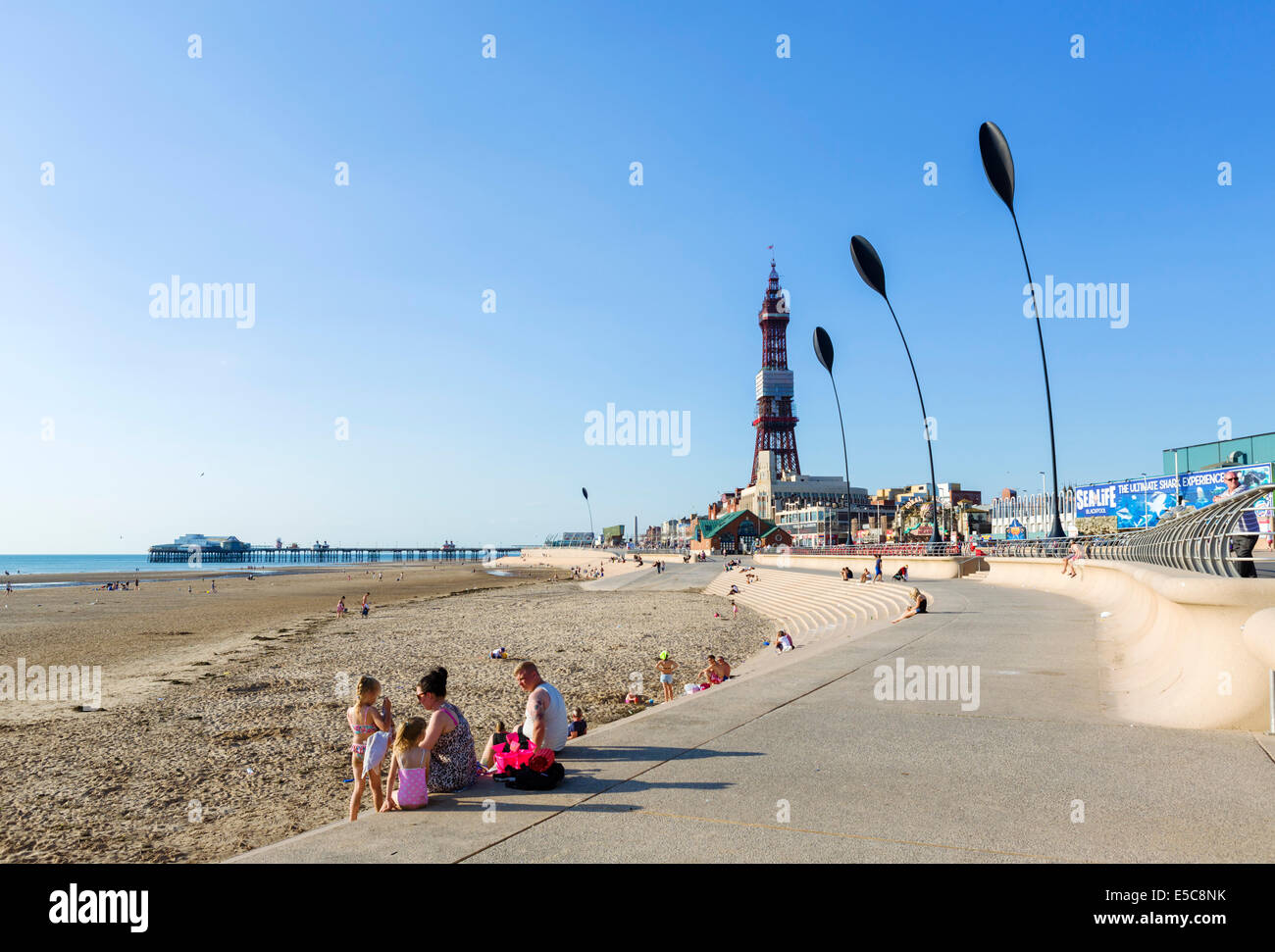 Beach and promenade in late afternoon looking towards North Pier and Blackpool Tower, The Golden Mile, Blackpool, Lancashire, UK Stock Photo