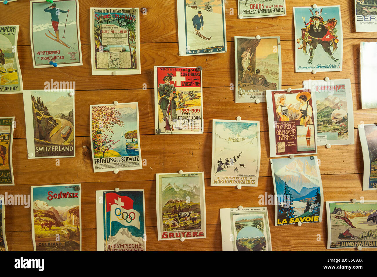 Old Swiss postcards, some dating back 100 years, pinned to the wall of a Swiss chalet Stock Photo