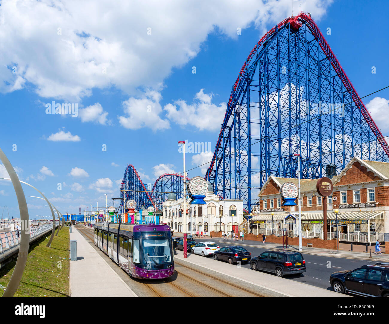 Tram on the promenade in front of the Big One roller-coaster at the Pleasure Beach amusement park, Blackpool, Lancashire, UK Stock Photo