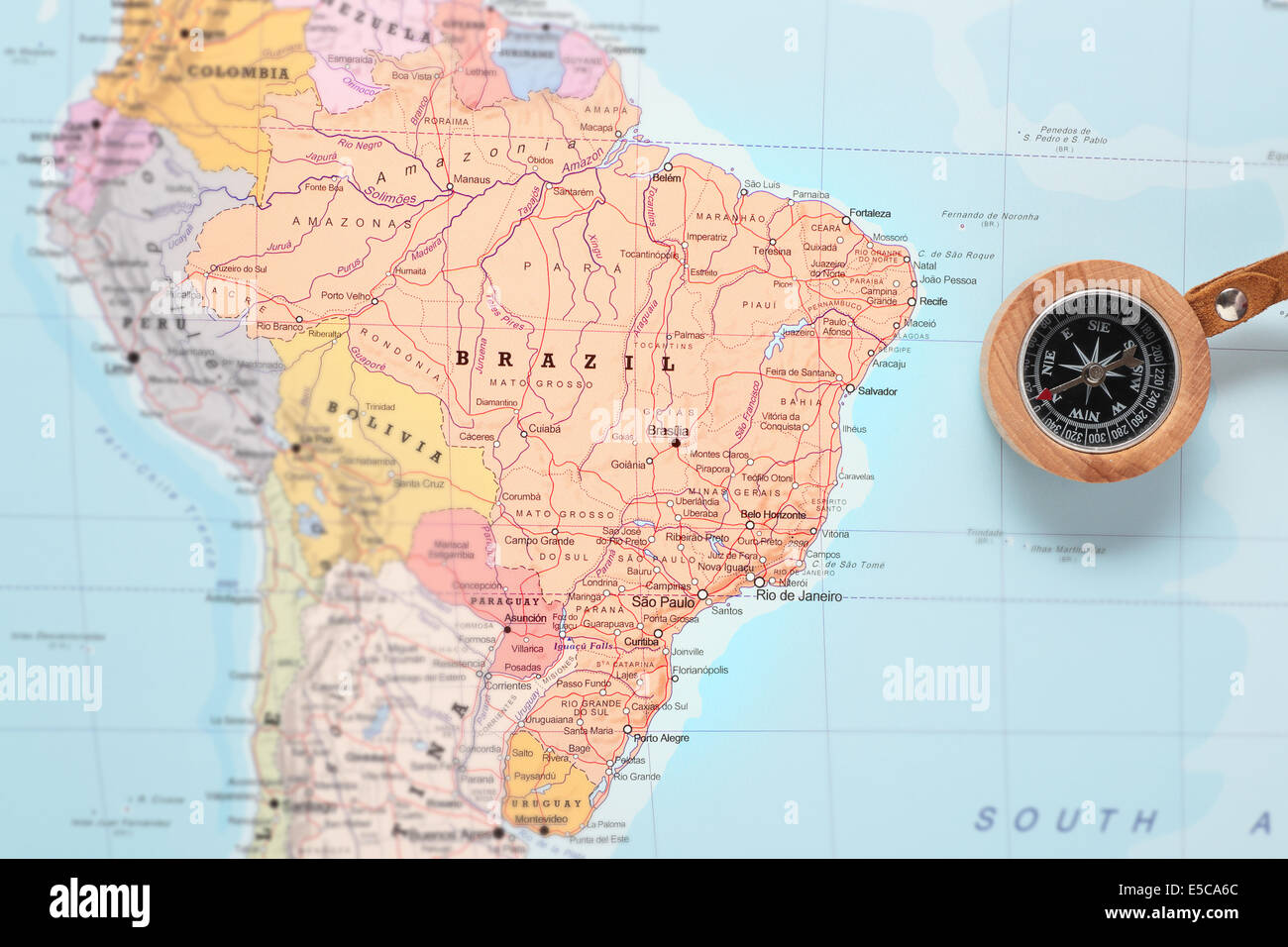 Compass on a map pointing at Brazil and planning a travel destination Stock Photo