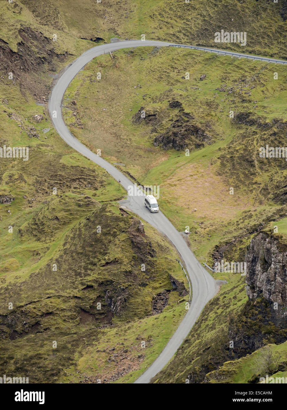 Looking down on small camper van on steep, winding, single track mountain road, Trotternish, Isle of Skye, Scotland, UK Stock Photo