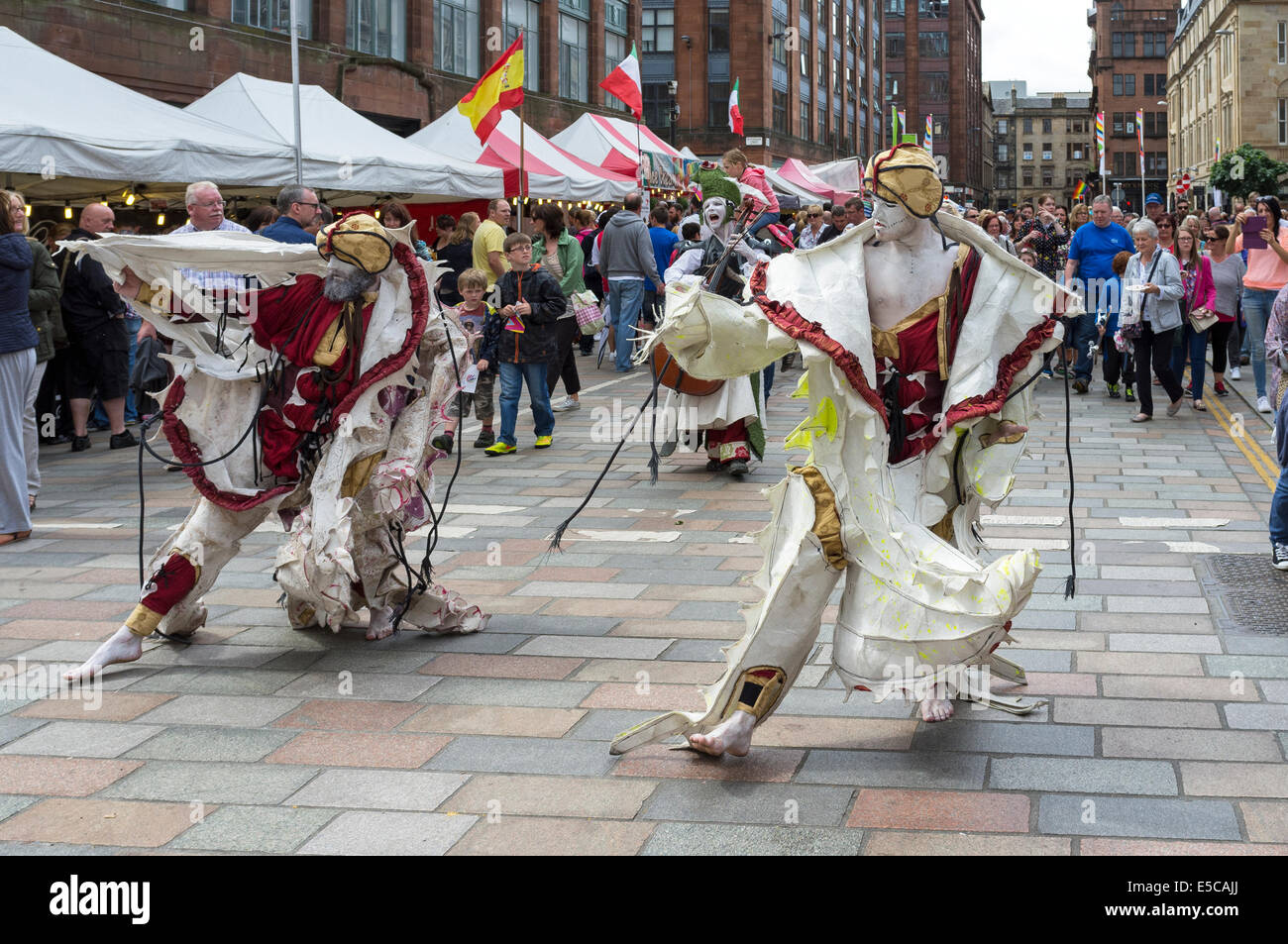 Street entertainers performing at the Merchant City festival during the Commonwealth Games, Glasgow, Scotland, UK Stock Photo