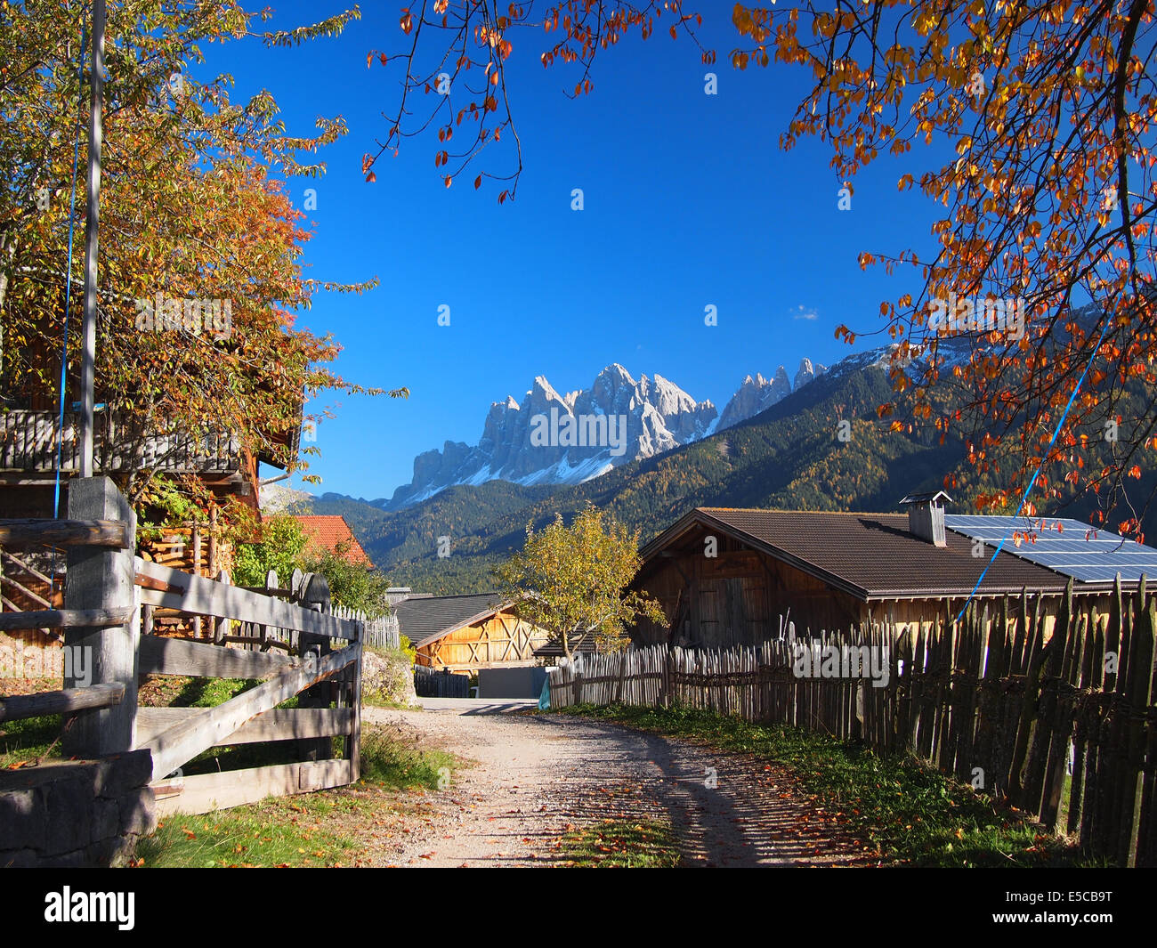 A rural village in the Funes Valley (Val di Funes) with in the background the Odle Dolomites mountain peaks in autumn in Italy. Stock Photo