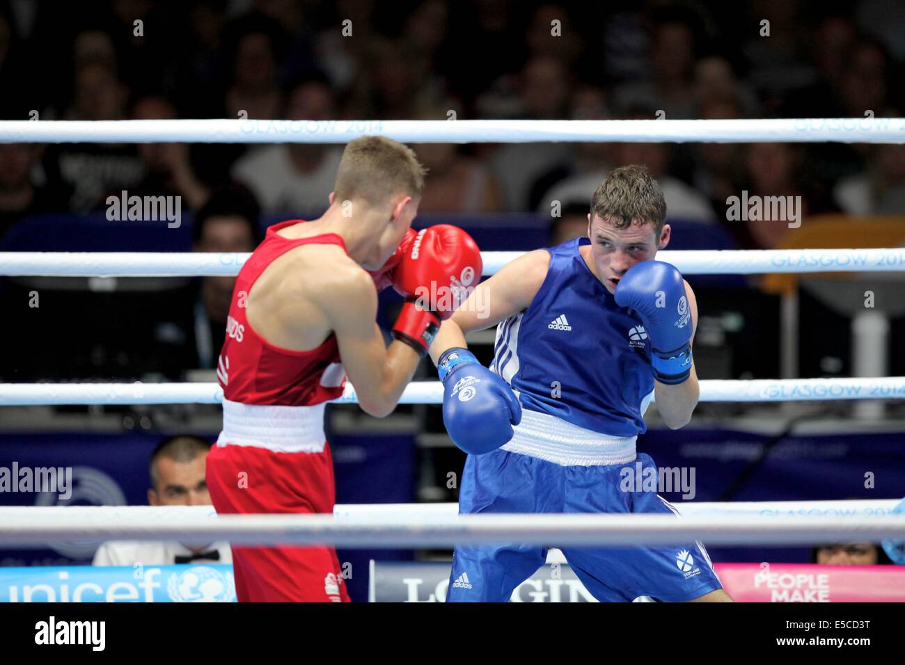 Glasgow, Scotland, UK. 27th July, 2014. Commonwealth Games day 4. Boxing - evening session.  Men's fly weight (52kg).  Reecs McFadden (Scotland, blue) beats Charlie Edwards (England, red) in the preliminaries Credit:  Neville Styles/Alamy Live News Stock Photo