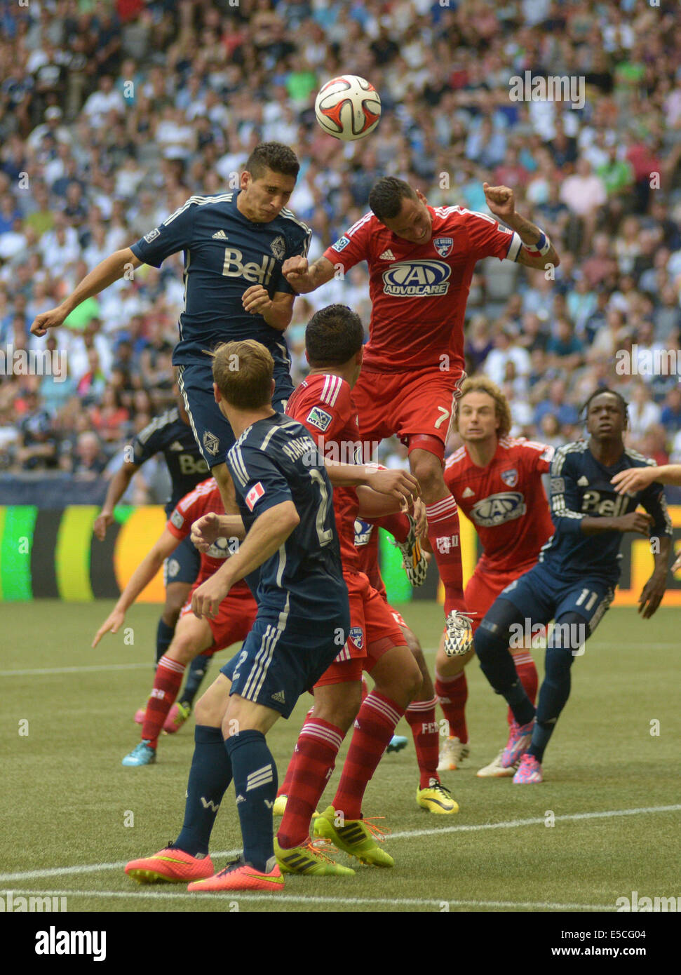 Vancouver, Canada. 27th July, 2014. Vancouver Whitecaps' Johnny Leveron (L) vies with FC Dallas' Blas Perez during their MLS soccer game at BC Place in Vancouver, Canada, on July 27, 2014. Vancouver Whitecaps tied FC Dallas 2-2. Credit:  Sergei Bachlakov/Xinhua/Alamy Live News Stock Photo