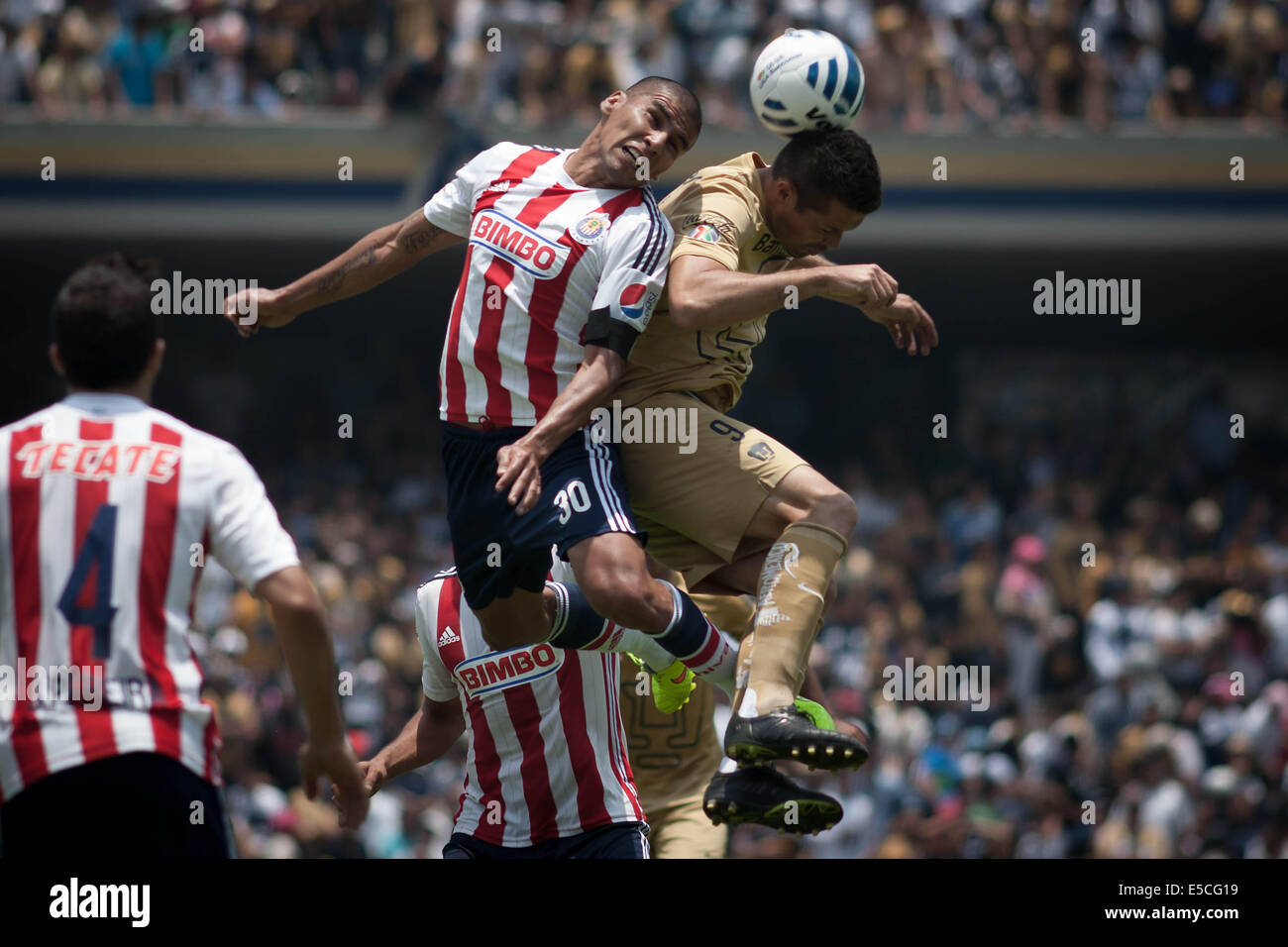 Mexico City, Mexico. 27th July, 2014. Dante Lopez (R) of UNAM's Pumas, vies the ball with Chivas' Carlos Salcido (L), during the match of the MX League Opening Tournament, held at Universitary Olympic Stadium in Mexico City, capital of Mexico, on July 27, 2014. © Pedro Mera/Xinhua/Alamy Live News Stock Photo