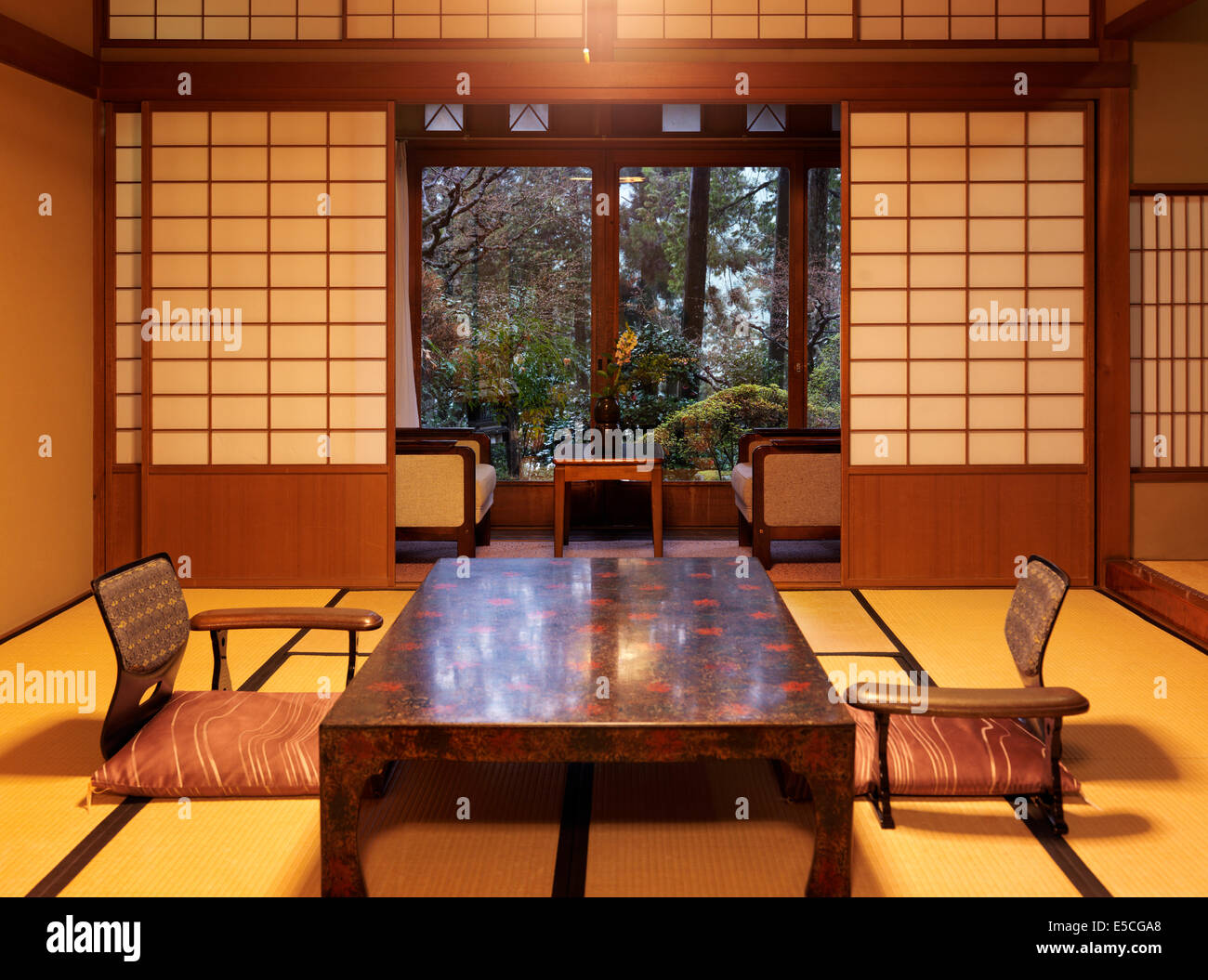 Japanese tea table chabudai and zaisu chairs at ryokan room with garden view in Gero, Japan Stock Photo