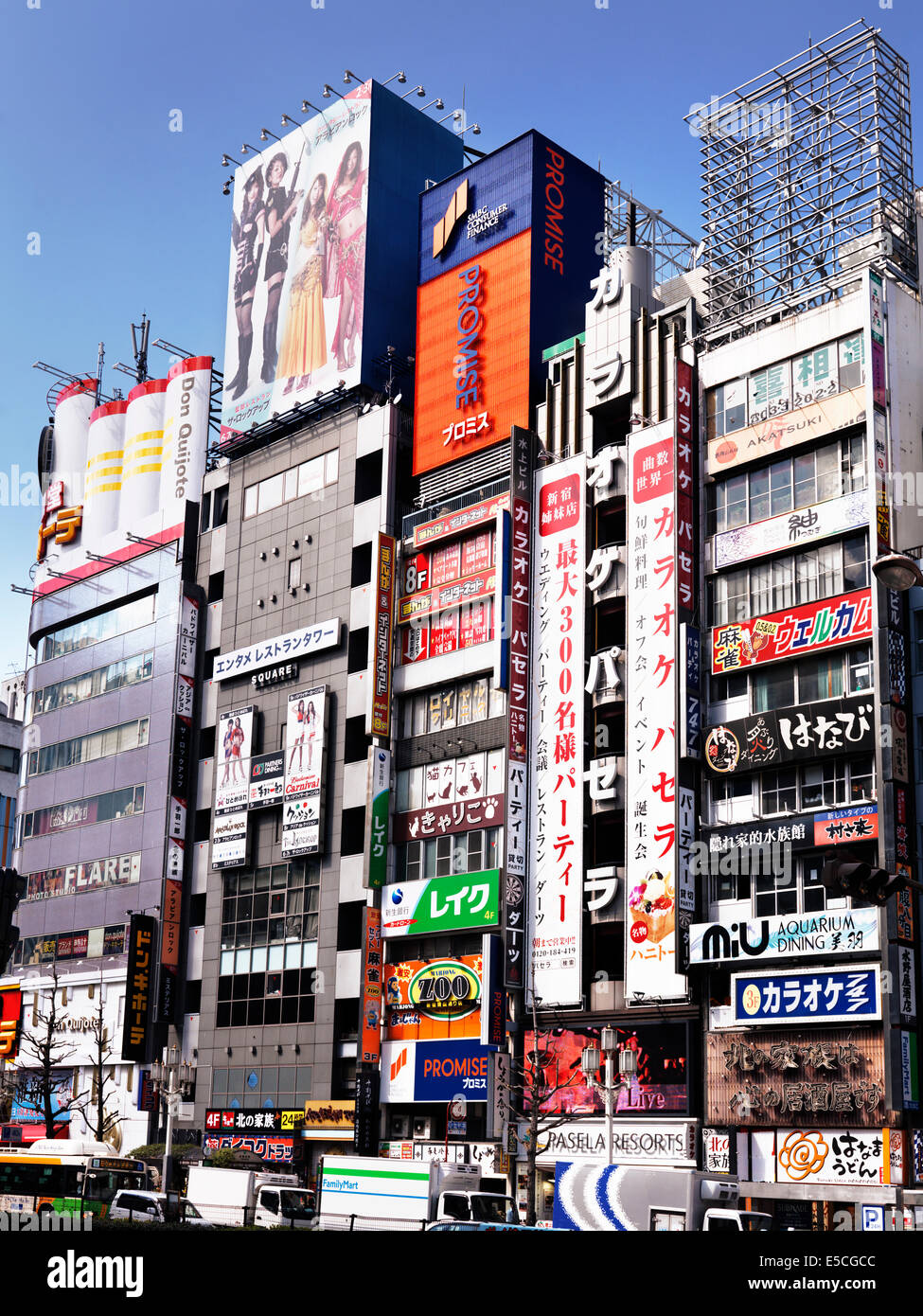 Buildings with store and restaurant signs on Yasukuni Dori street, Shinjuku, Tokyo, Japan 2014 Stock Photo