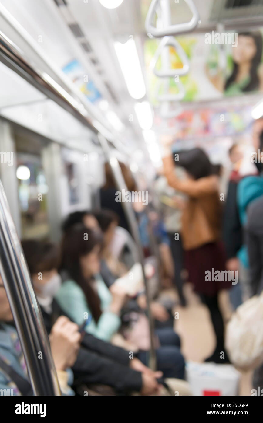 People riding a subway train abstract out-of-focus background. Tokyo Metro, Tokyo, Japan. Stock Photo