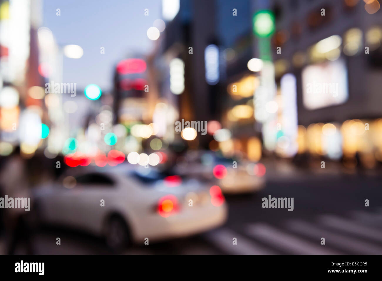 Abstract out-of-focus city streets scenery with colorful lights at dusk in Ginza, Tokyo, Japan. Stock Photo
