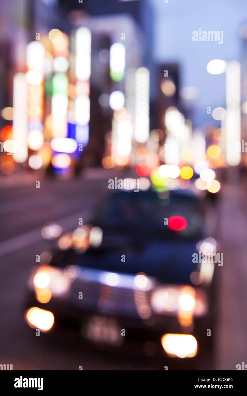 Abstract out-of-focus city scenery of a taxi cab on the streets of Ginza, Tokyo, Japan. Stock Photo