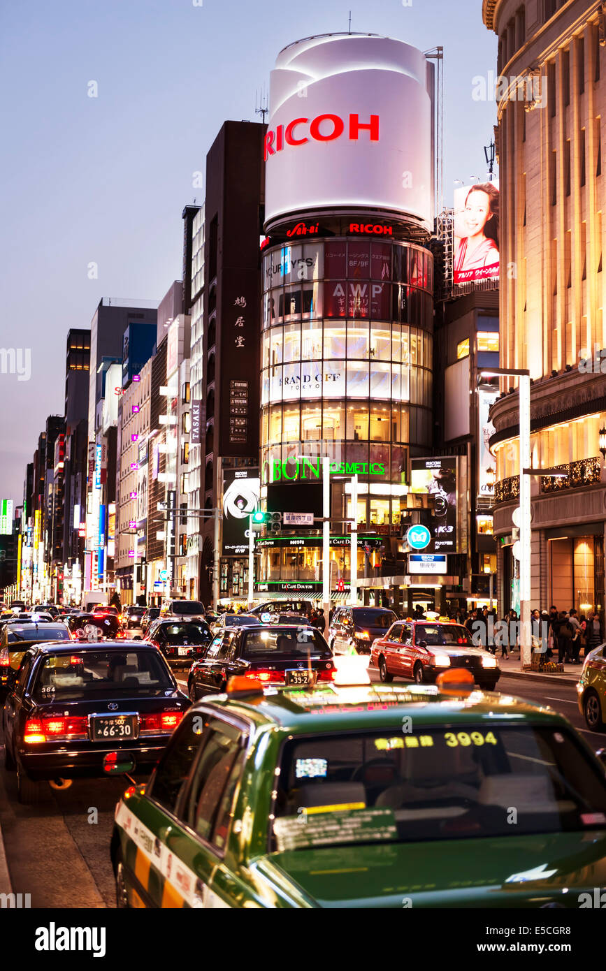 Cars on brightly lit Ginza, Tokyo streets at night. Japan 2014. Stock Photo