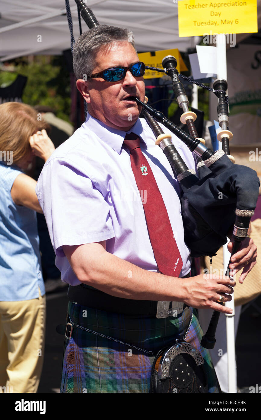 Well dressed man wearing kilt and Playing Bagpipe Stock Photo