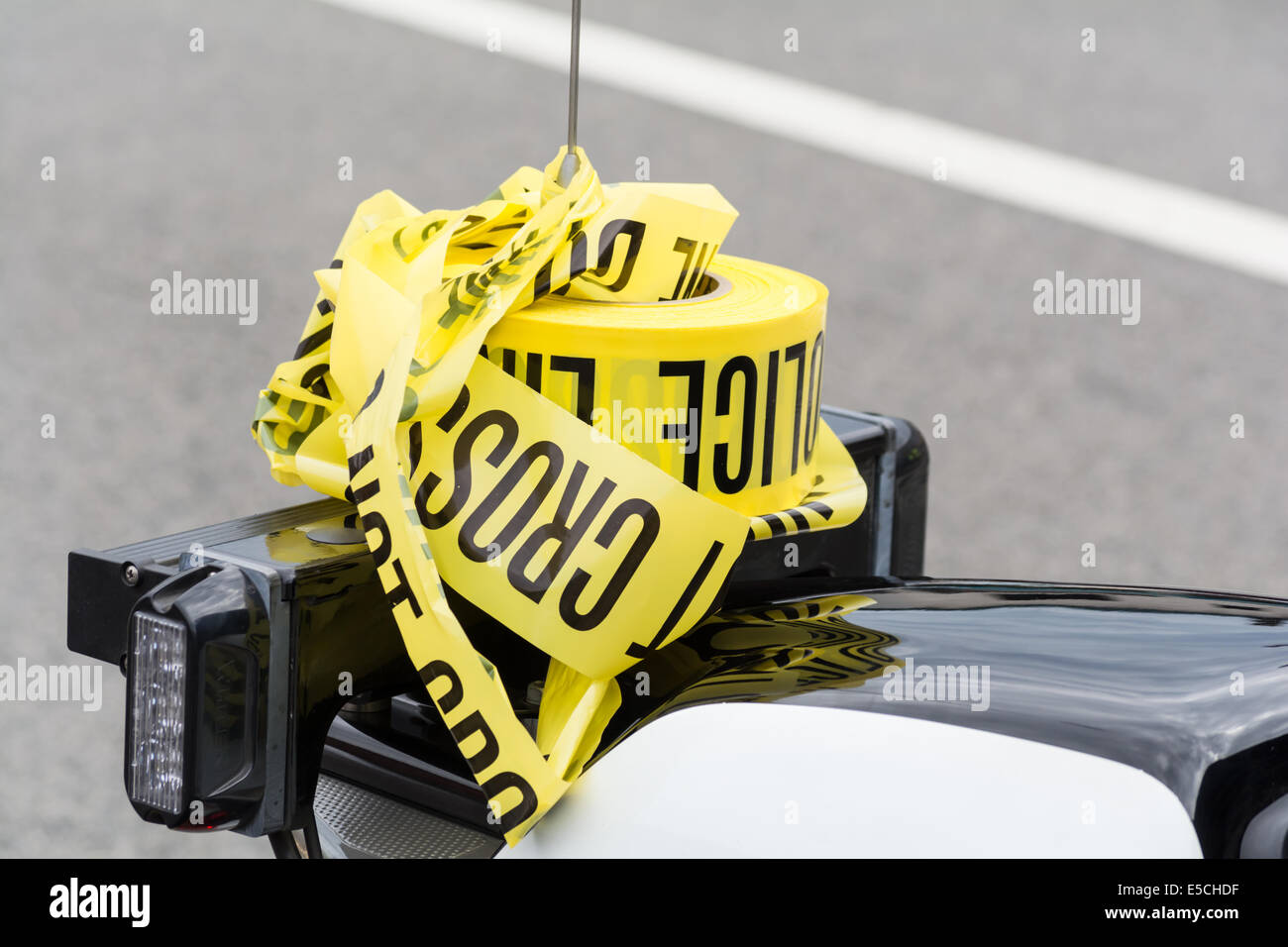 July 19, 2014 - Glendale California, United States. Police caution tape stored on the radio antenna of a police motorcycle. Stock Photo