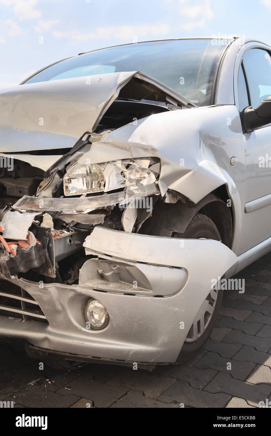 a demolished car after an accident on the street Stock Photo