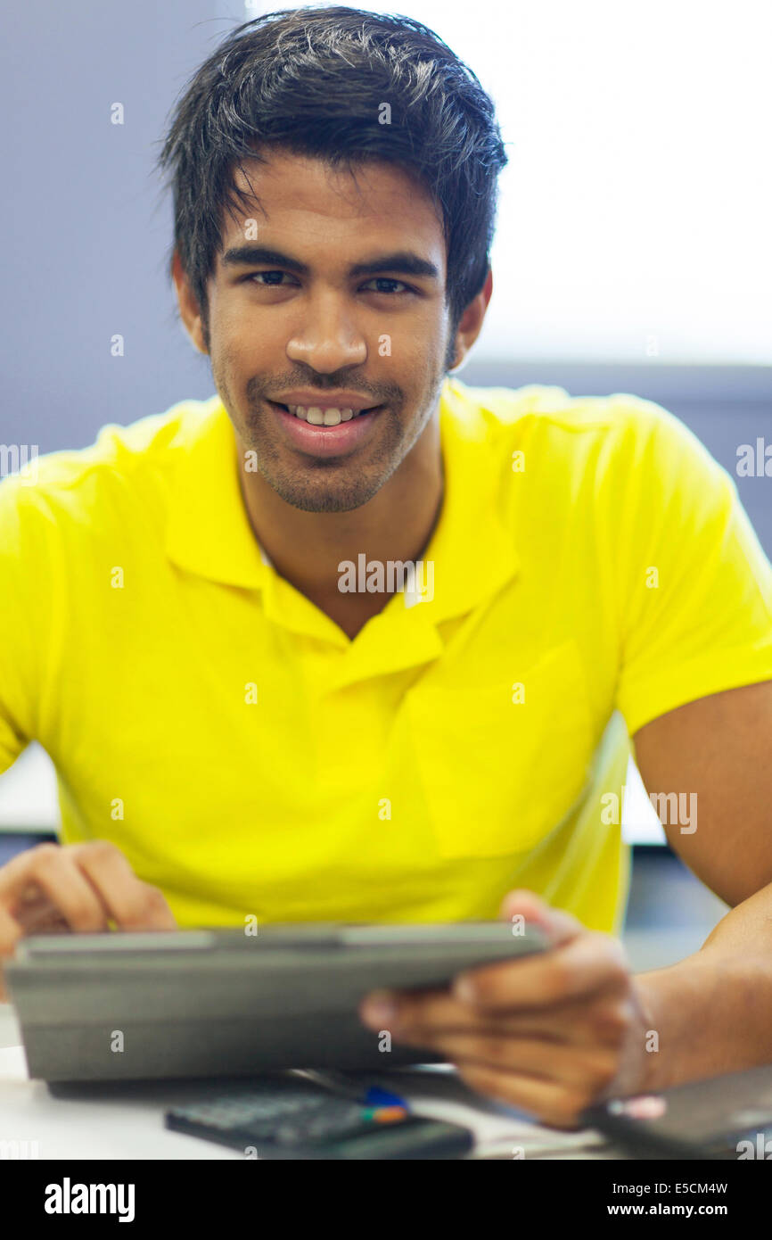 handsome male university student using tablet computer in lecture room Stock Photo