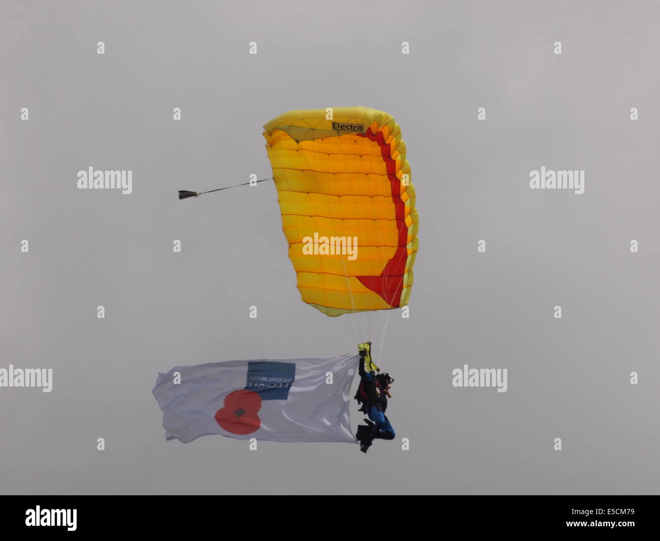 parachutist with Royal British Legion poppy on flag flag flying from behind Stock Photo