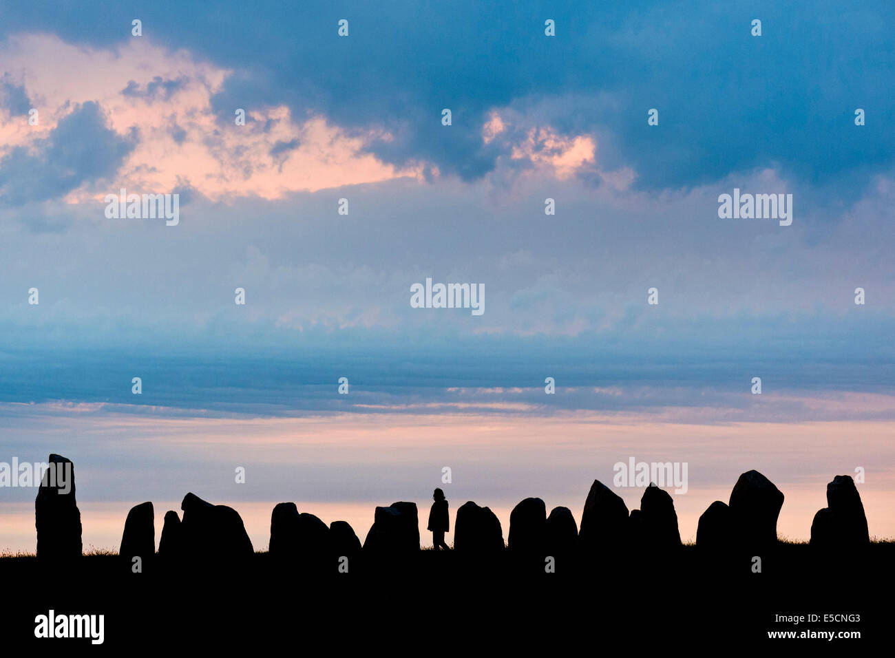 Visitors at the Ale's Stones,largest preserved stone ship in Scandinavia, sunset, Kåseberga, Scania, Sweden Stock Photo