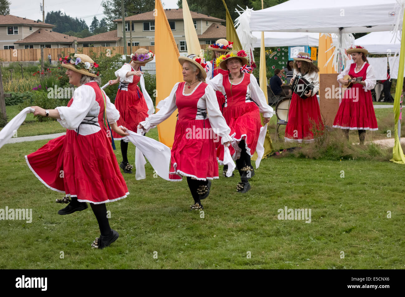 The women of Tiddley Cove Morris Dancers doing a traditional dance at a Midsummer Fete festival Stock Photo