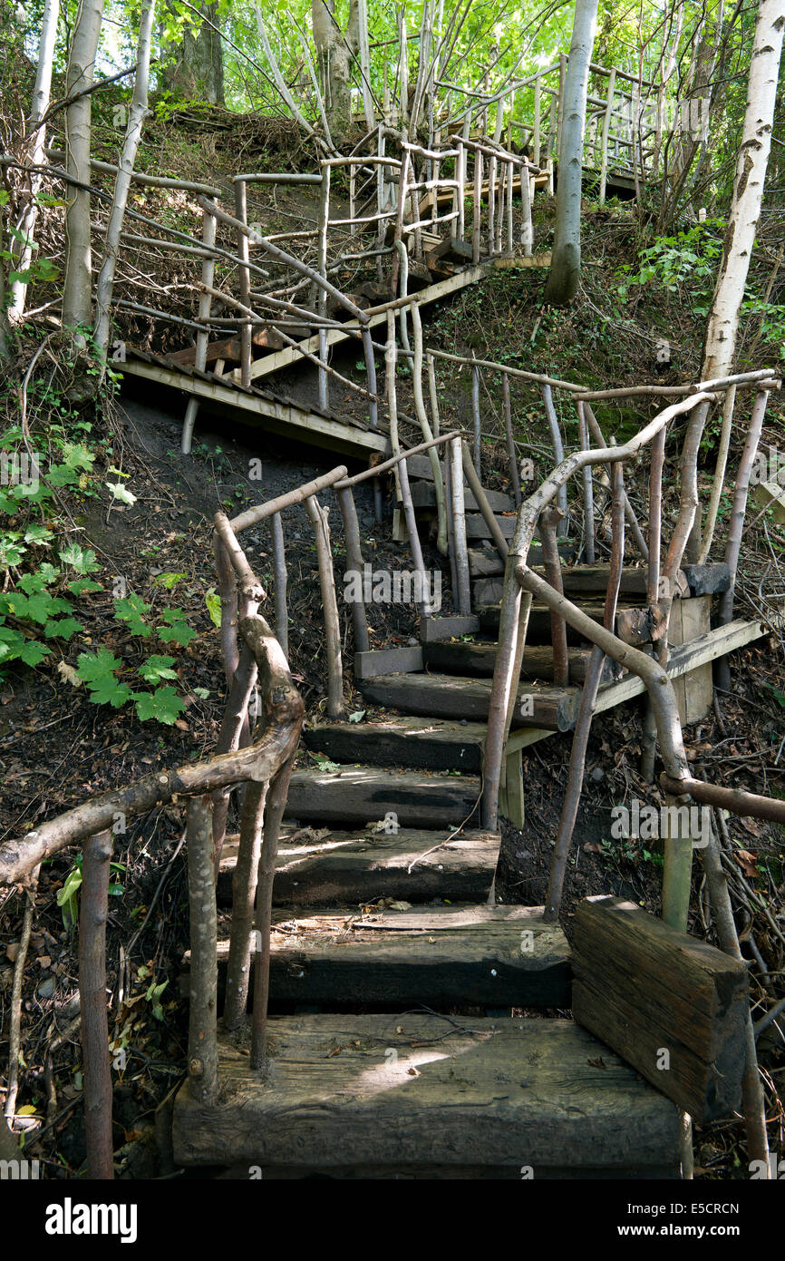 Rustic wooden steps down the banking in the garden Stock Photo