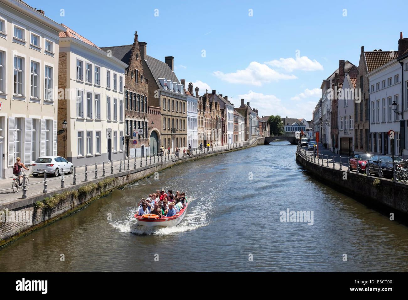 Tourists on a boat trip on Bruges canal, Belgium. Stock Photo