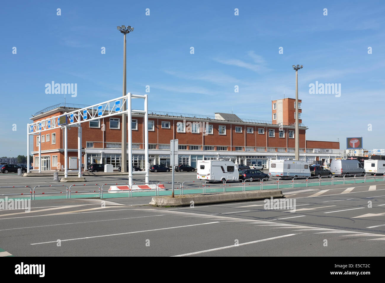 Vehicles waiting for boarding the ferry near to one of the buildings at Calais Port, France Stock Photo